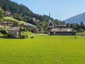 A rural village with houses, a church, and a mountain in the background. - Chalet with Mountain Views in Wald (Wald-Königsleiten)