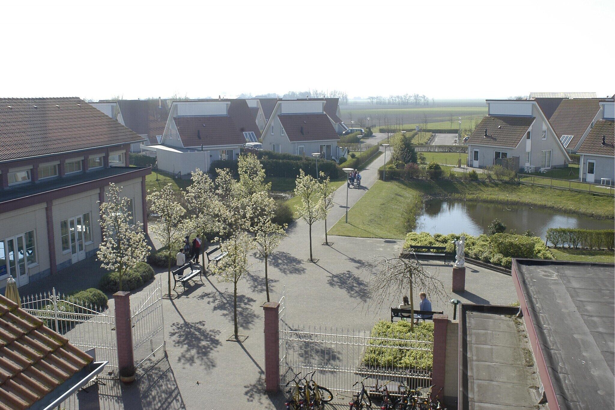 A residential area with houses, a pathway, and a small body of water.