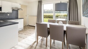A modern kitchen with a dining area.