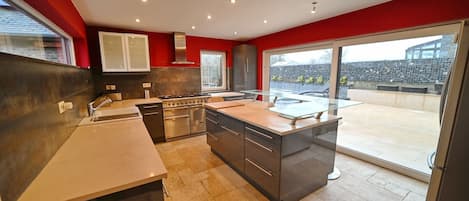 Fridge, stovetop, dishwasher, coffee/tea maker