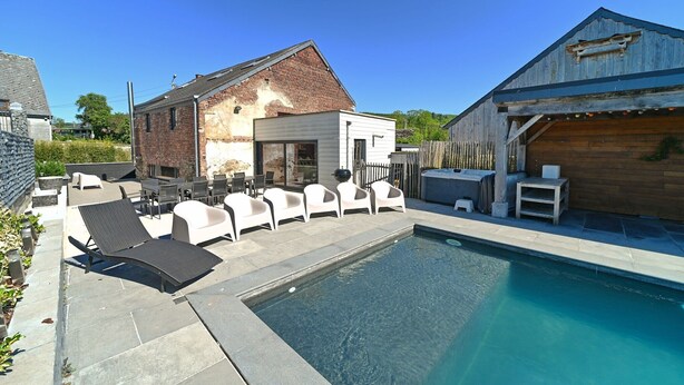 A backyard with a swimming pool, outdoor seating, and a rustic building. - Village House in Ambly with Outdoor Pool (Nassogne, Ambly)