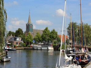 Stroll along the serene river, surrounded by historic architecture and picturesque boats.