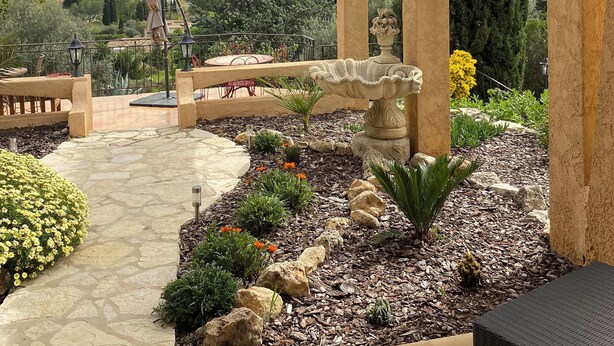 A patio area with a stone pathway, a pergola, and a view of the landscape. - La Joséline  (Flayosc)