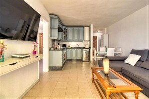 Cozy living space with a kitchen area, dining table, and comfortable seating.
