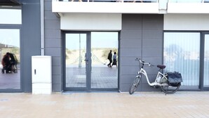 A modern building entrance with a bicycle parked outside. - Studio in Nieuwpoort near the Beach (Nieuwpoort)