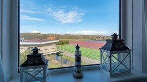 A view from a window with two decorative lanterns on a ledge. - Apartment by the Beach with Stunning Dunes (Julianadorp aan Zee)