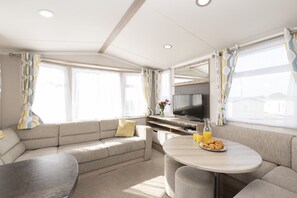 Relax in this cozy living area with a comfortable sofa, dining table, and flat-screen TV.