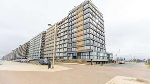 A multi-story residential building with a modern design, featuring balconies and large windows. - Studio Apartment in Seaside with Panoramic Views (Middelkerke)