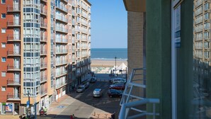 A high-rise building with multiple balconies overlooking a beach. - Partial Sea View Apartment (Middelkerke)