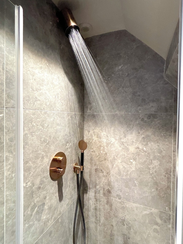 Shower, hair dryer, towels, toilet paper
