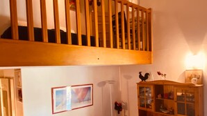 A cozy room with a loft bed, a sofa with red cushions, a wooden cabinet, and a framed picture on the wall. - V0736 - Holiday villa for 6 people 2 steps from the beach - terrace and parking lot (Vias)
