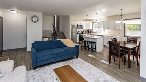 A modern apartment with a living room, kitchen, and dining area. - Ankeny Heights - A 4 bedroom and 2 bath home (Ankeny)