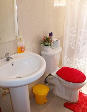 Comfort Apartment, Balcony, City View | Bathroom | Shower, slippers, towels, soap - Lux suites Jimka Apartments Kisumu (Kisumu)