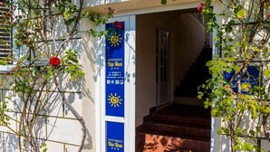 A building entrance with a sign for 'Apartments Blue Moon'.