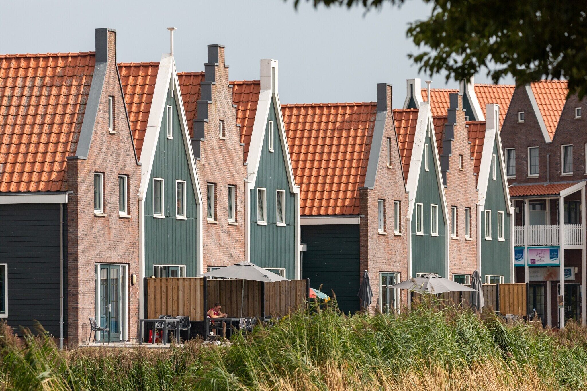 A row of traditional Dutch houses with steep gabled roofs and brick facades.