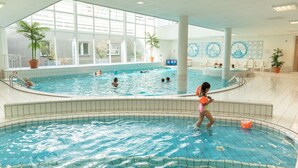 An indoor swimming pool with multiple lanes, surrounded by tiled walls and large windows. - Stylish Stay in Volendam (Volendam)