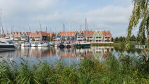 A marina with boats docked in front of traditional houses with red roofs. - Stylish Stay in Volendam (Volendam)