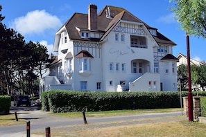 Situated in a residential area, this traditional building features a two-story facade with a balcony and decorative elements.