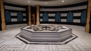 A circular room with a central ornate table, patterned walls, and a herringbone floor. - Cozy 2-bedroom apartment with AC, fitness room, WiFi in phenomenal Antalya (Antalya)