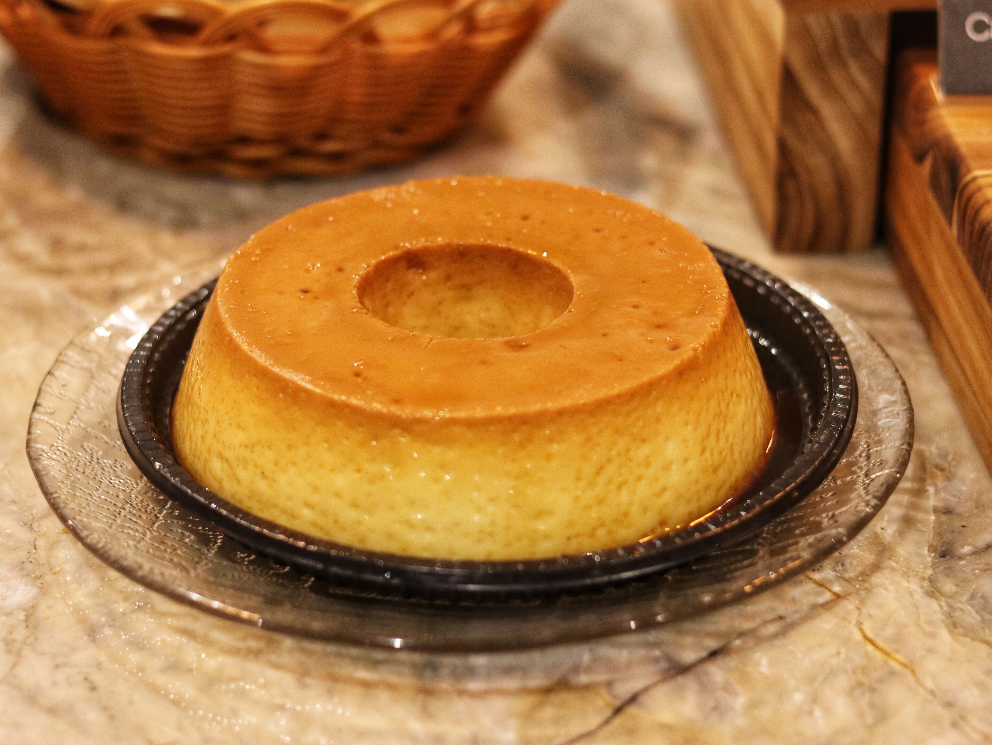 A round cake with a hole in the center on a glass plate.