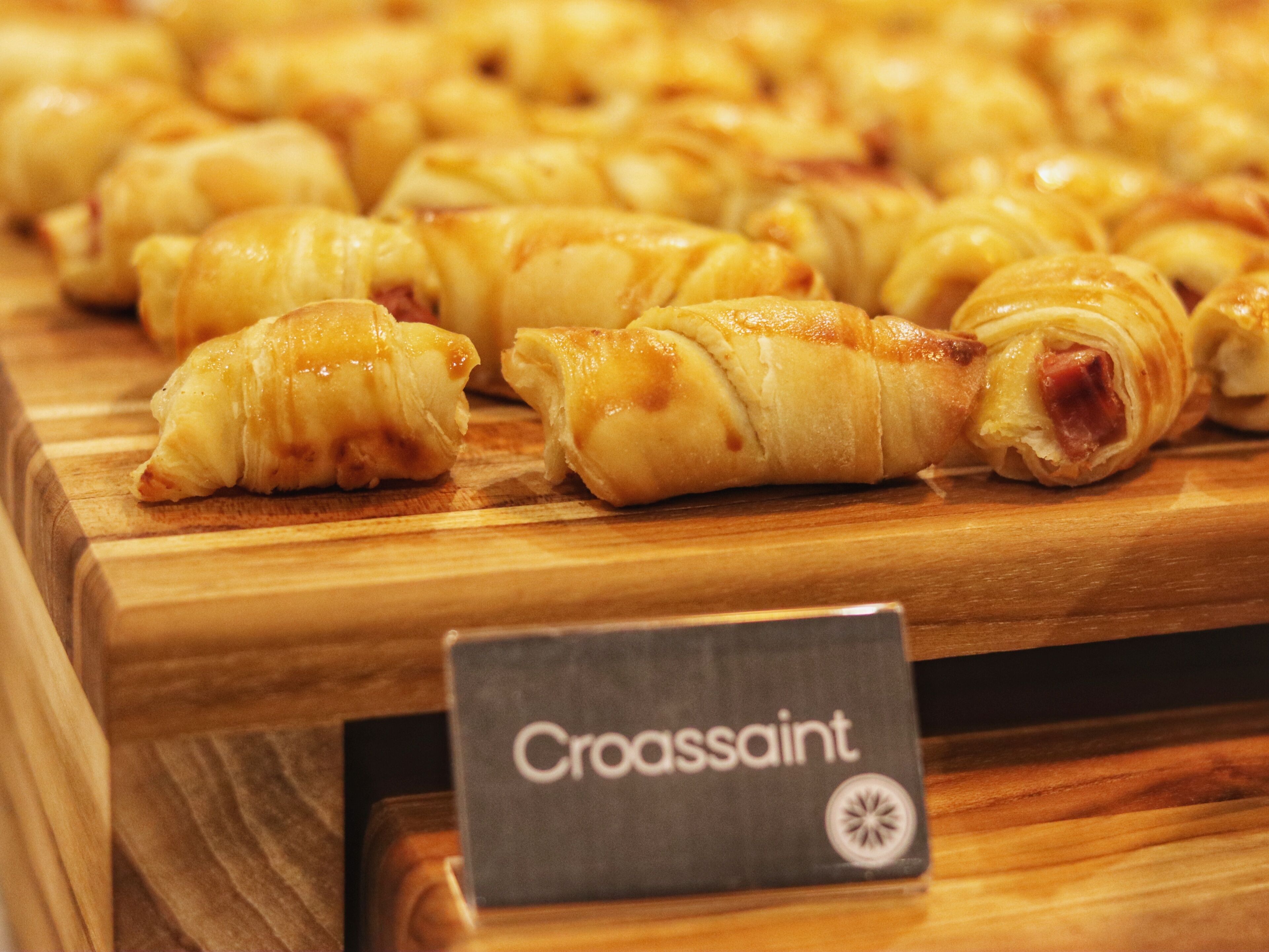 A display of croissants with a sign labeled "Croissant."