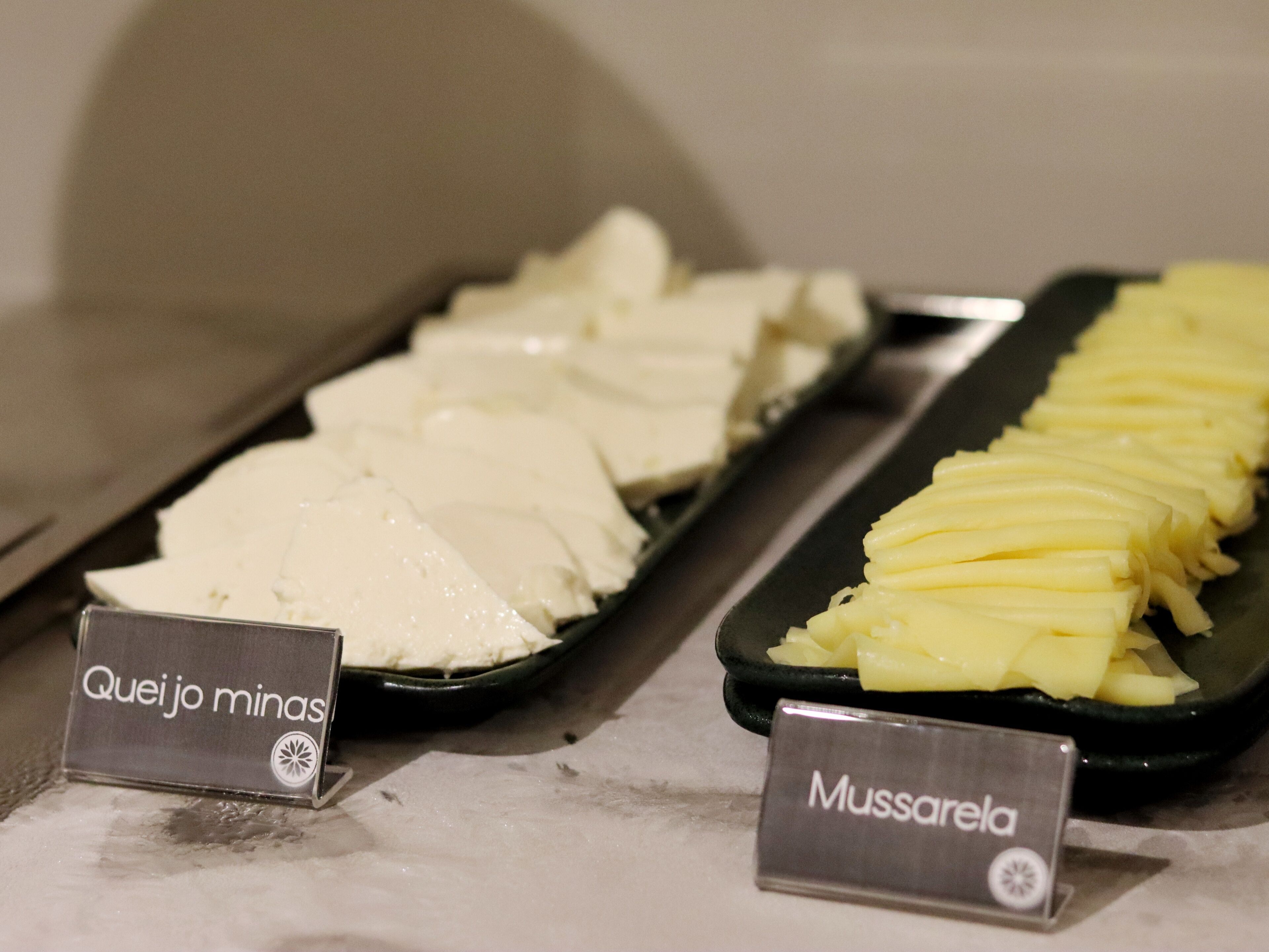 A buffet with cheese and sliced potatoes.