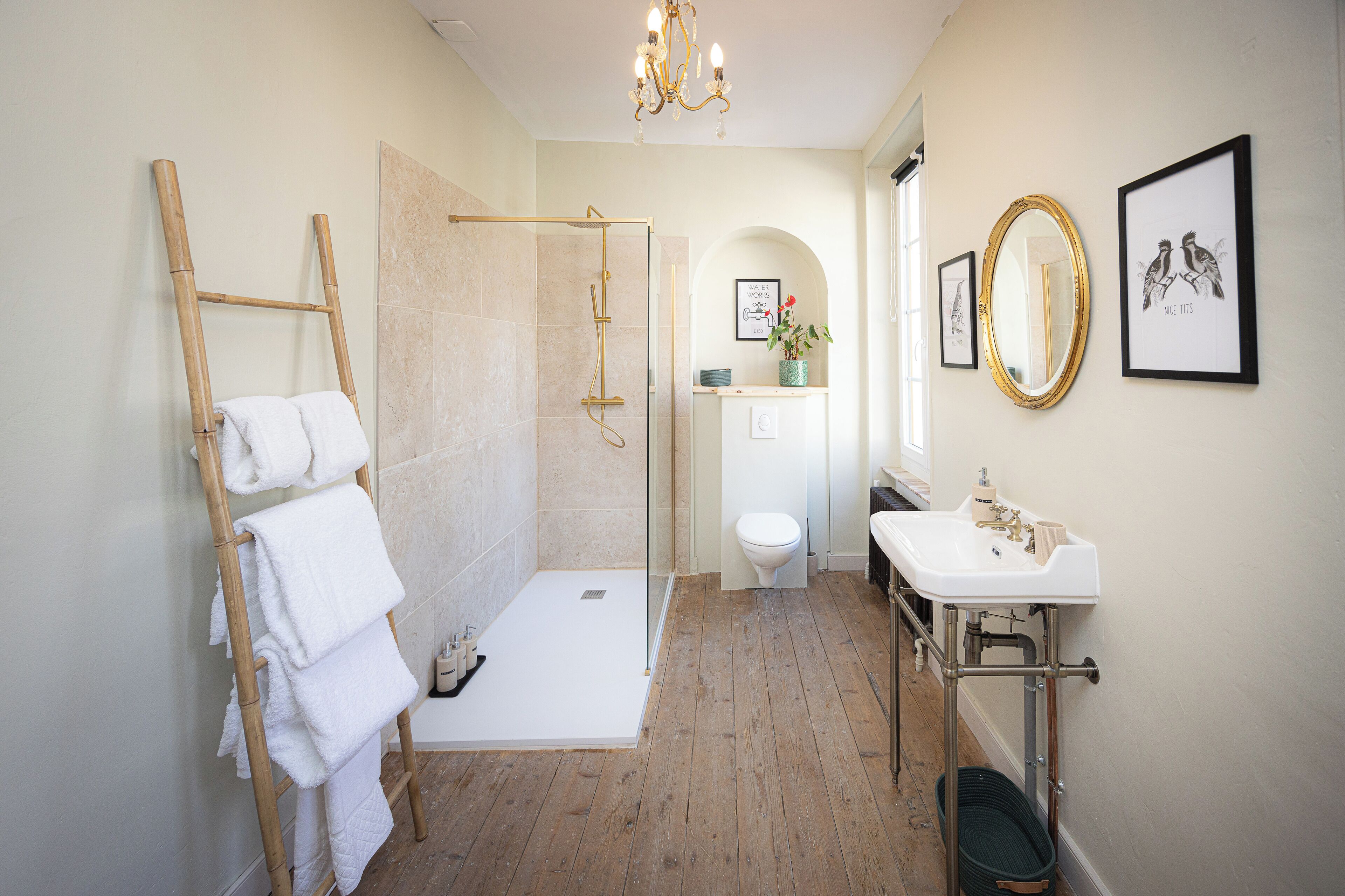 A modern bathroom with a shower, toilet, and sink.