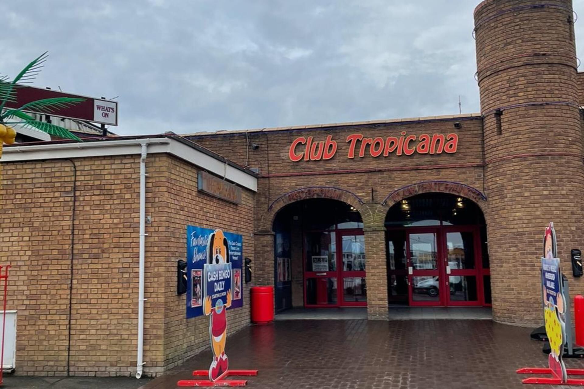 Club Tropicana with brick facade and arched entrance.