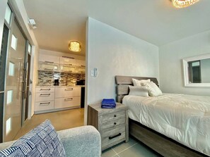 Cozy retreat with a single bed, bedside table, and comfortable bench.