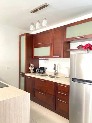 Enjoy cooking in this well-equipped kitchen with a refrigerator, oven, and coffee maker.