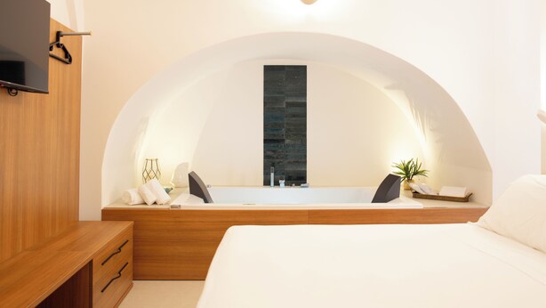 A modern bathroom with a freestanding bathtub, a wooden vanity, and a large mirror.
