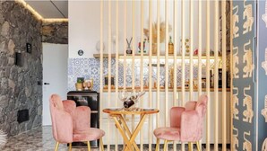 A modern interior with a stone wall, a kitchen area with patterned tiles, and a decorative wall with animal motifs.