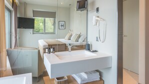 A modern bathroom with a large sink, a mirror, a hairdryer, and a window. - Villa Selina in Nikiana (Lefkada)