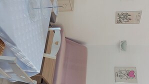 A room with a bed, a desk, a chair, a television, and wall decorations. - Mini villa with private garden - Residence with swimming pool Lecci near Porto-Vecchio (Lecci)
