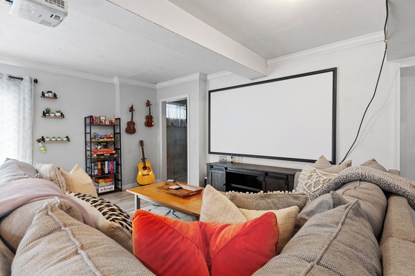 Cozy movie nights just got an upgrade! home theater setup with projector screen.