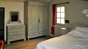 A bedroom with a bed, dresser, wardrobe, and a window with curtains. - La Caracole :Provencal villa with heated pool, tennis court, nature at your doorstep (Caseneuve)
