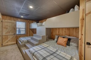 A compact room with bunk beds, a window, and a door. - Lakefront Home & Guest House with Two Docks, and Breathtaking Mountain Views! (Hiawassee)