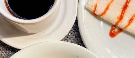 Three white plates with food items and a small bowl of sauce.