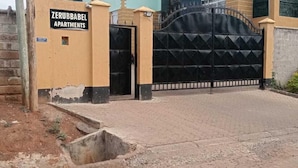 A gated entrance to a building with a sign reading "ZERUBABEL APARTMENTS." - Lux Suites Zerubabel penthouse Kisumu (Kisumu)