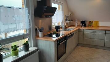 Fridge, stovetop, dishwasher, coffee/tea maker