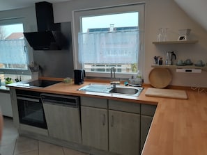 Fridge, stovetop, dishwasher, coffee/tea maker