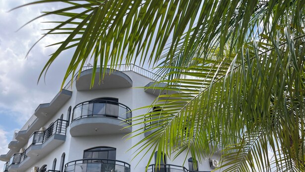 A multi-story building with balconies and a reception area. - Gutierrez Hotel (Americana)