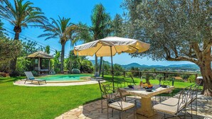 A pool area with a gazebo, outdoor seating, and a view of the landscape. - New! Villa Beni - Santa Eulalia (Ibiza)