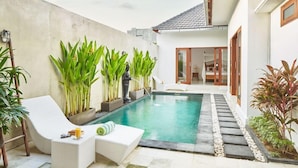 A private pool area with lounge chairs and potted plants. - Maisaba Seminyak Loft and Villas (Bali)