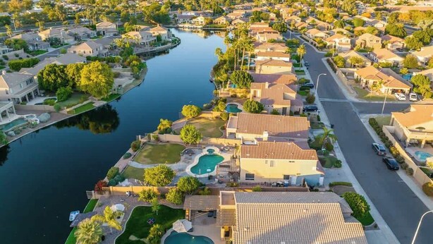 A residential area with houses, a canal, and a swimming pool. - Waterfront Villa with Pool Hot Tub Lounge area (Chandler)