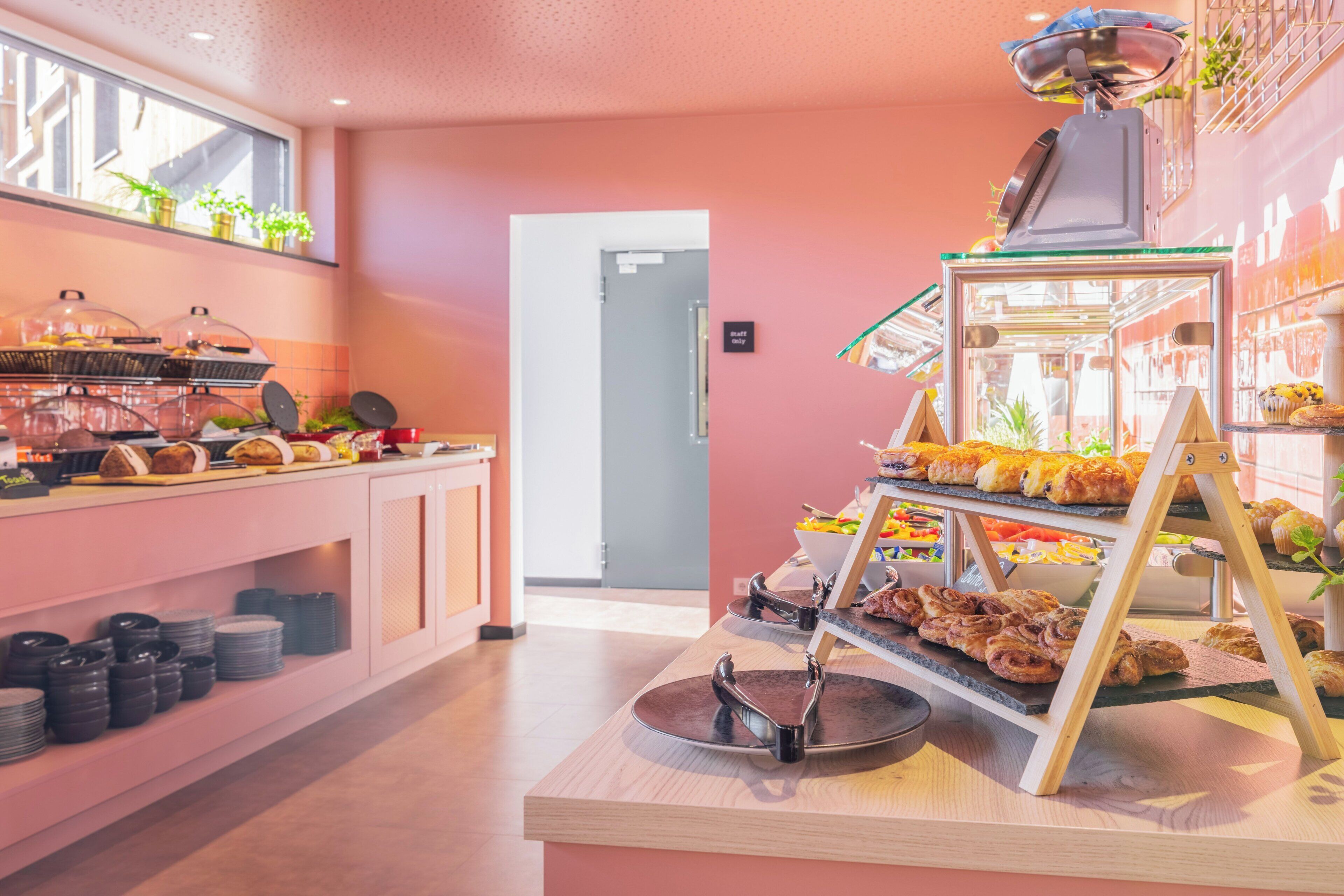 A buffet area with various food items and a coffee station.