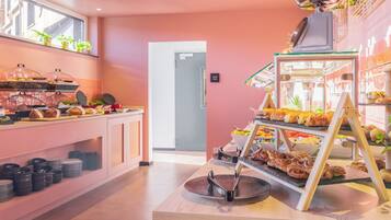 A buffet area with various food items and a coffee station.
