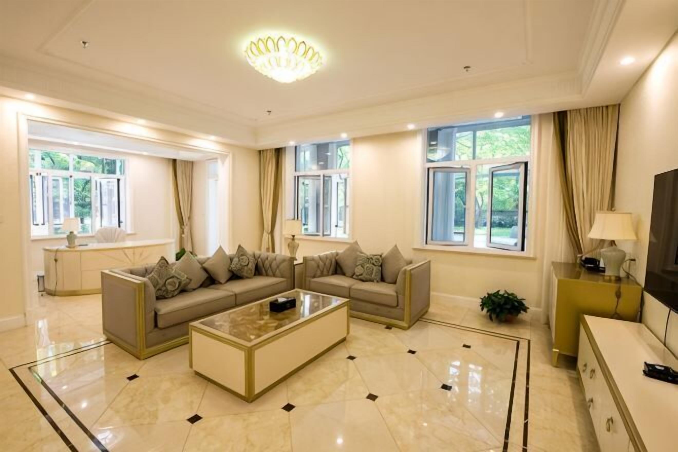 A spacious living room with a sectional sofa, a coffee table, and a TV.