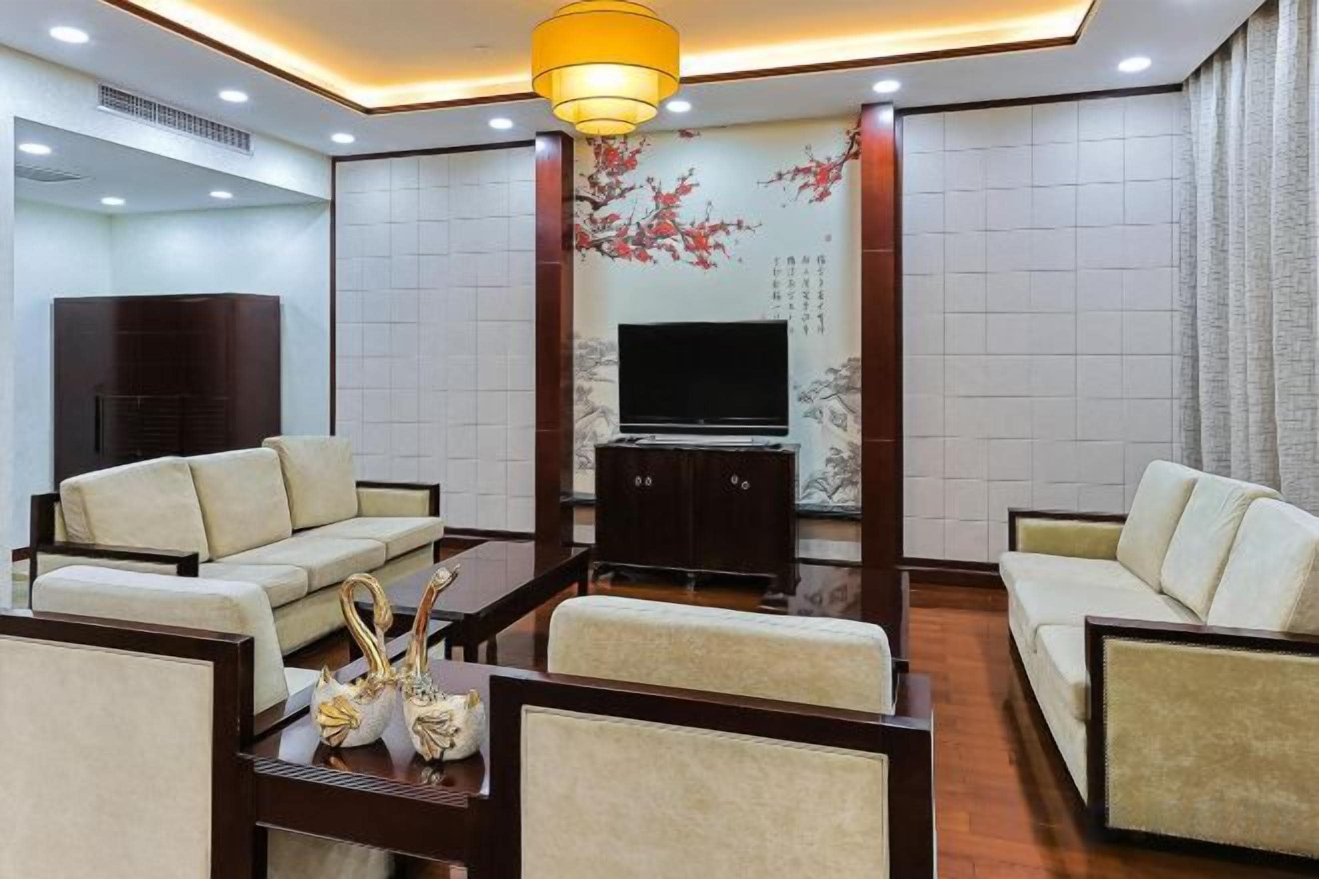 A modern living room with sofas, a coffee table, and a TV.