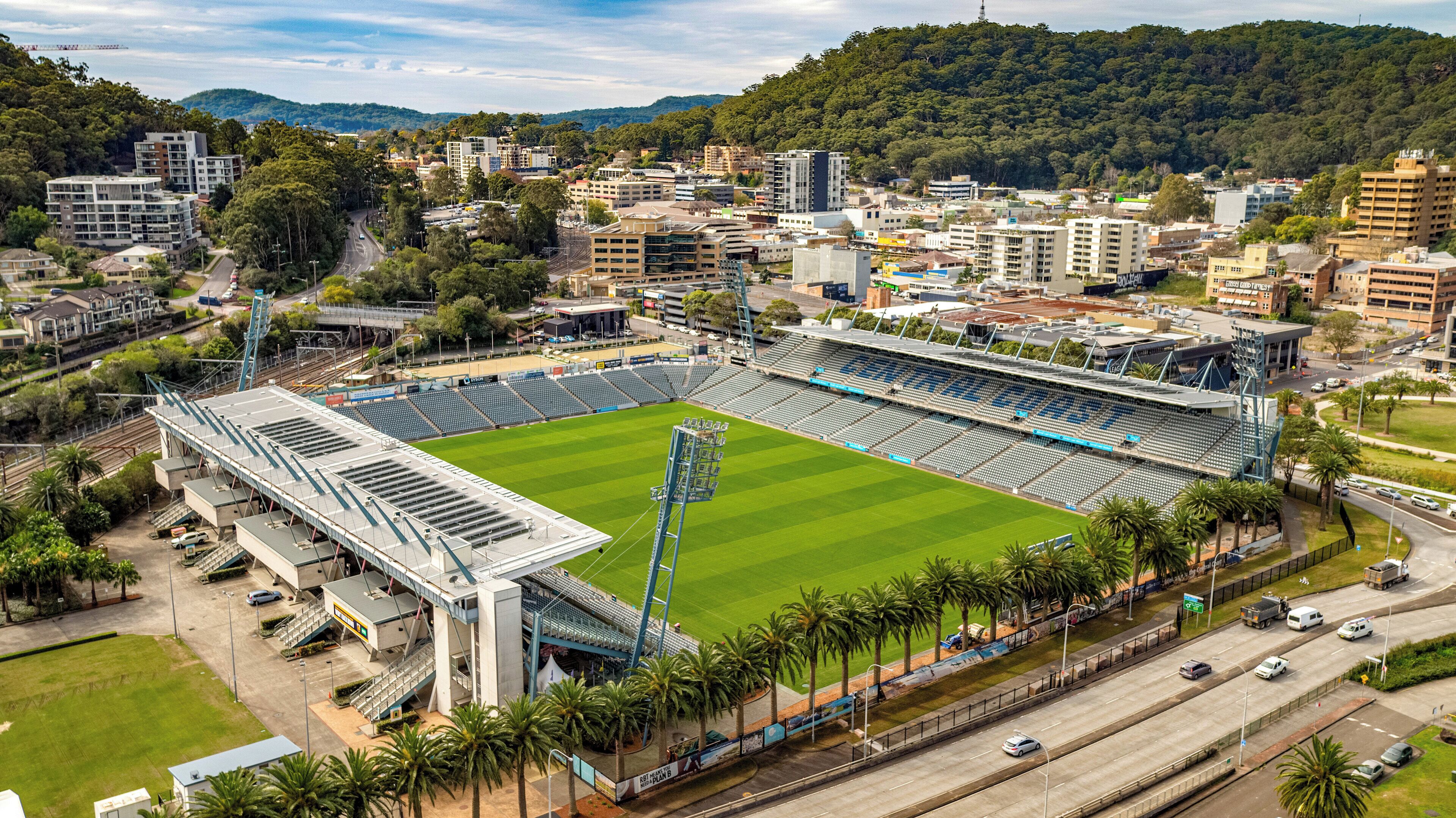 A stadium with a large seating area, surrounded by roads and buildings.